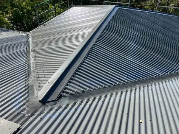 New corrugated metal roof extension meeting the existing roof in Hornsby