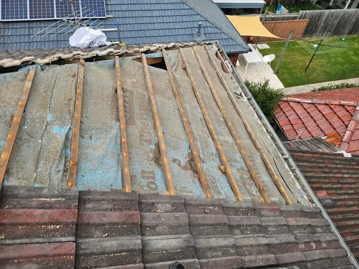 Before: old timber battens exposed under lifted tiles in Maroubra