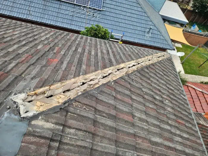 Cracked and broken ridge capping before repair
