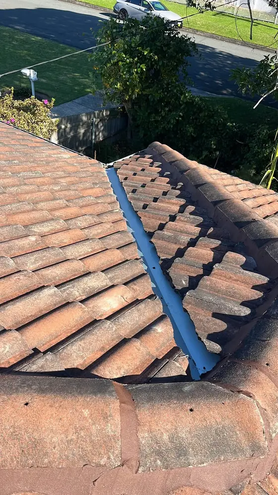 New metal valley iron laid between terracotta tiles